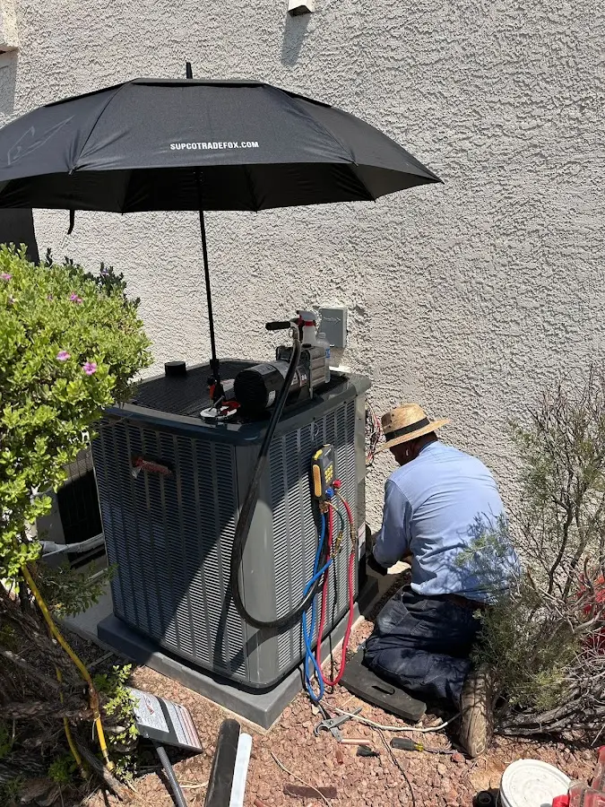 HVAC technician performing outdoor AC maintenance in Butler